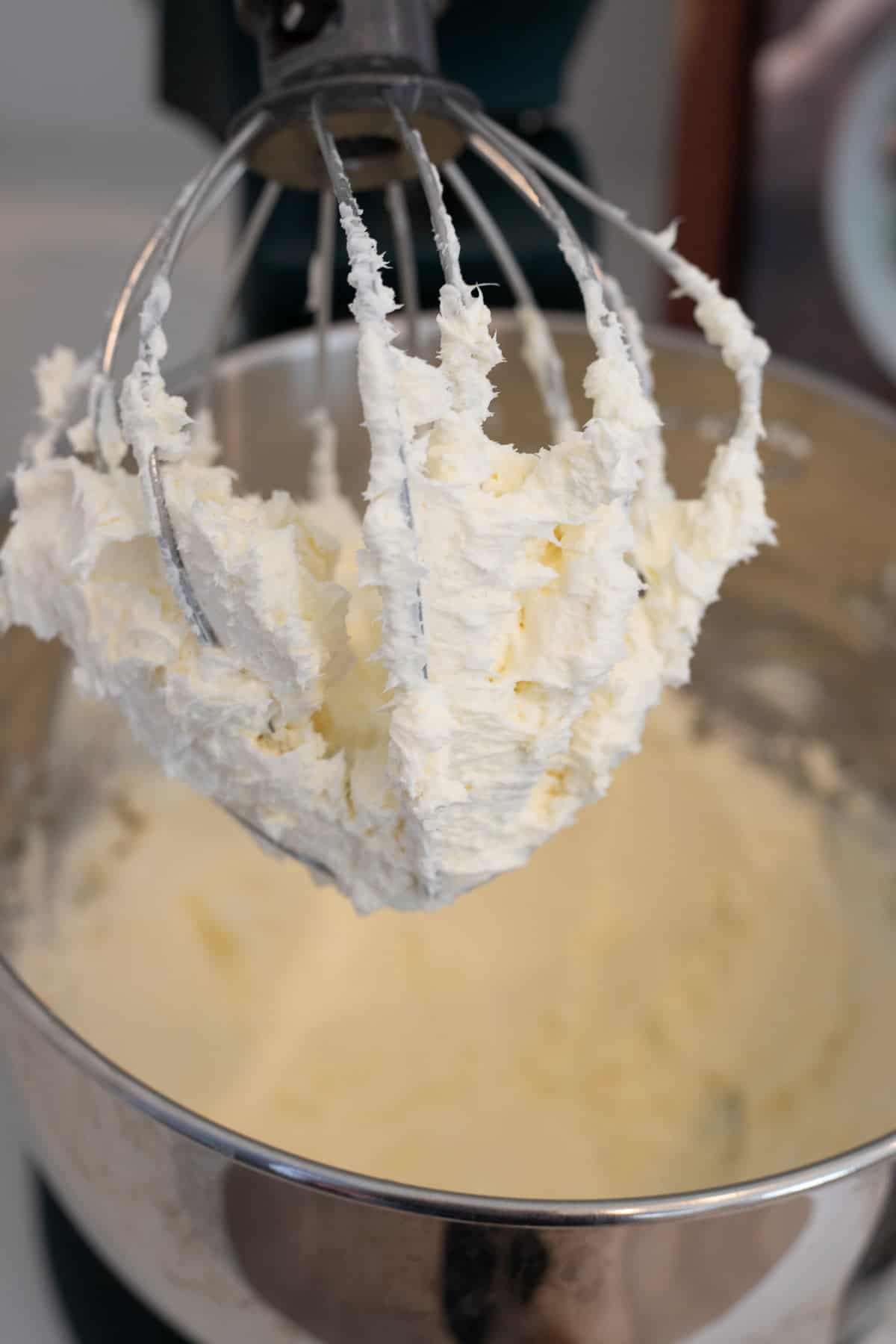 Whisk attachment that shows whipped butter and cream cheese.