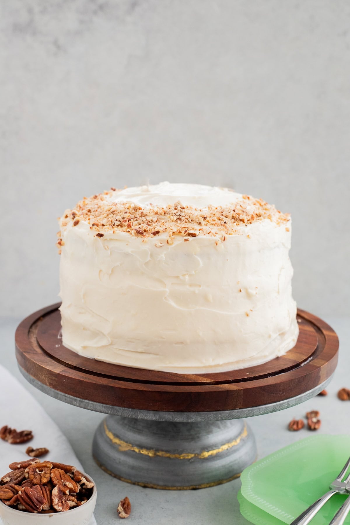 A hummingbird cake on a wooden and metal cake stand.