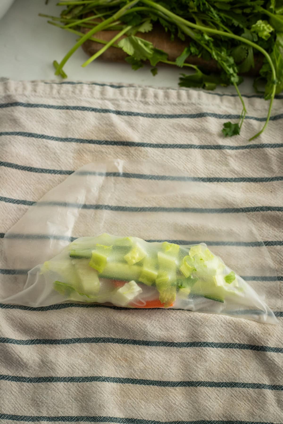 Rice paper folded over chopped veggies.