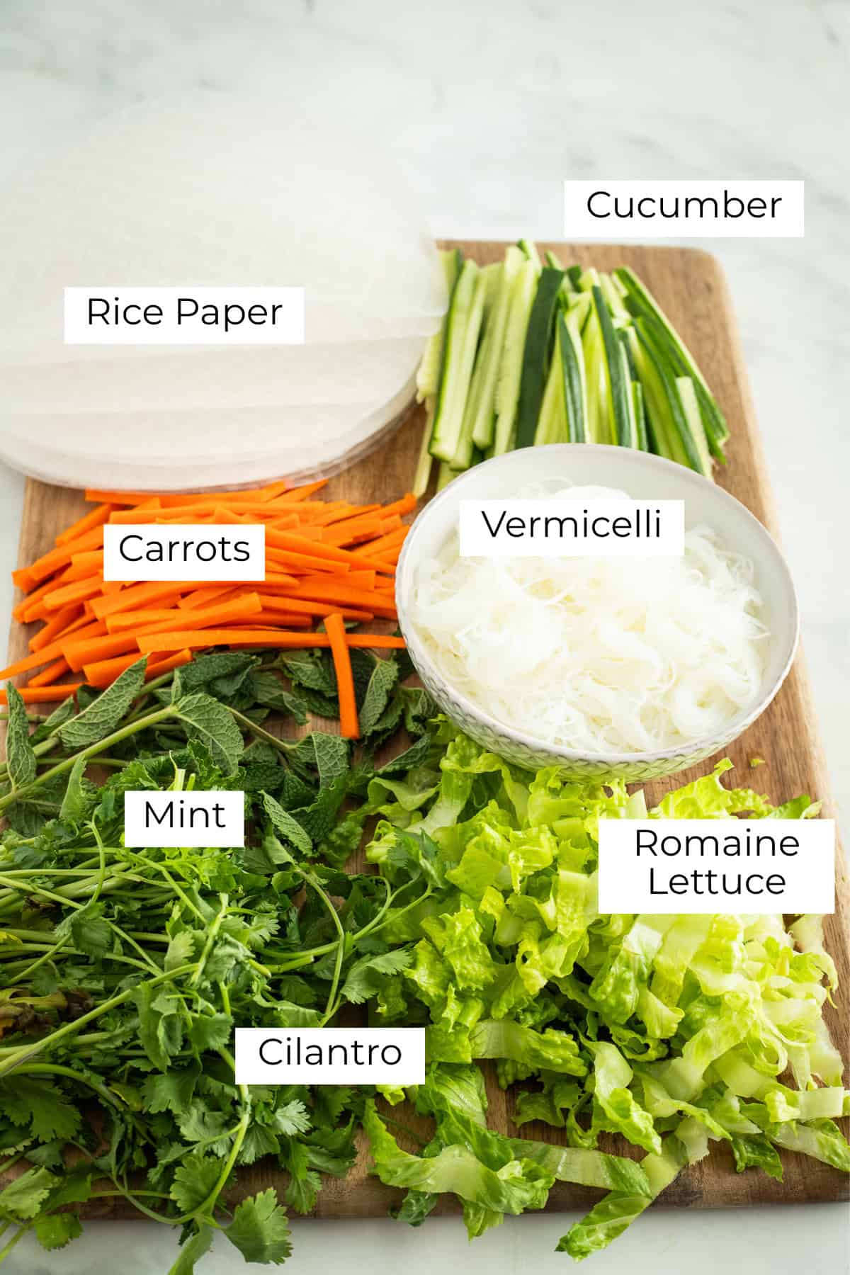 Chopped ingredients laid out for spring rolls.